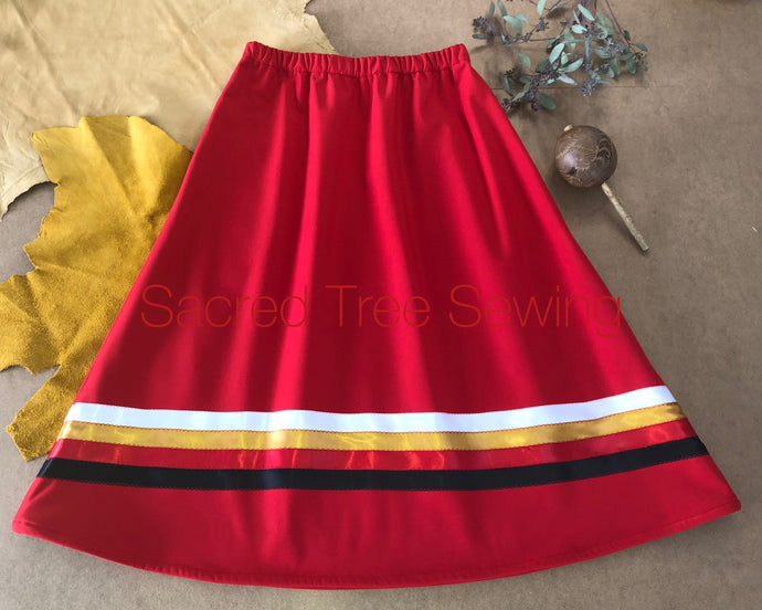 Red rain skirt with black, red, gold and white ribbons