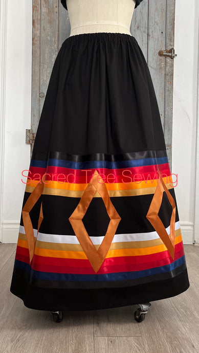 Seven golden diamonds adorn red, orange, gold, navy and black ribbons on a black skirt, front view