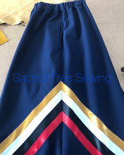 Load image into Gallery viewer, Pocket view, Blue rain skirt with red, black, white and gold ribbons
