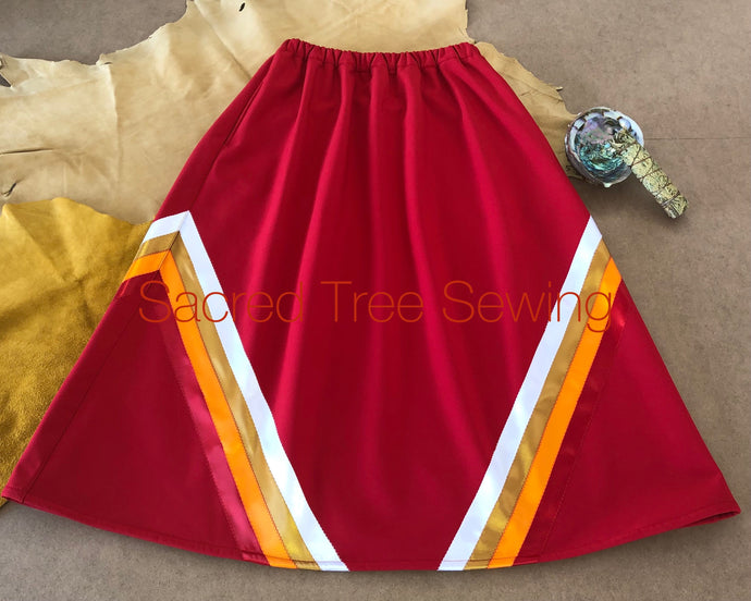 Red rain skirt with red, orange, gold and white ribbons